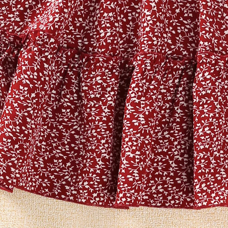 Close-up of red fabric with white floral pattern from Beach Fashion Girls Red Floral Halter Skirt Sets