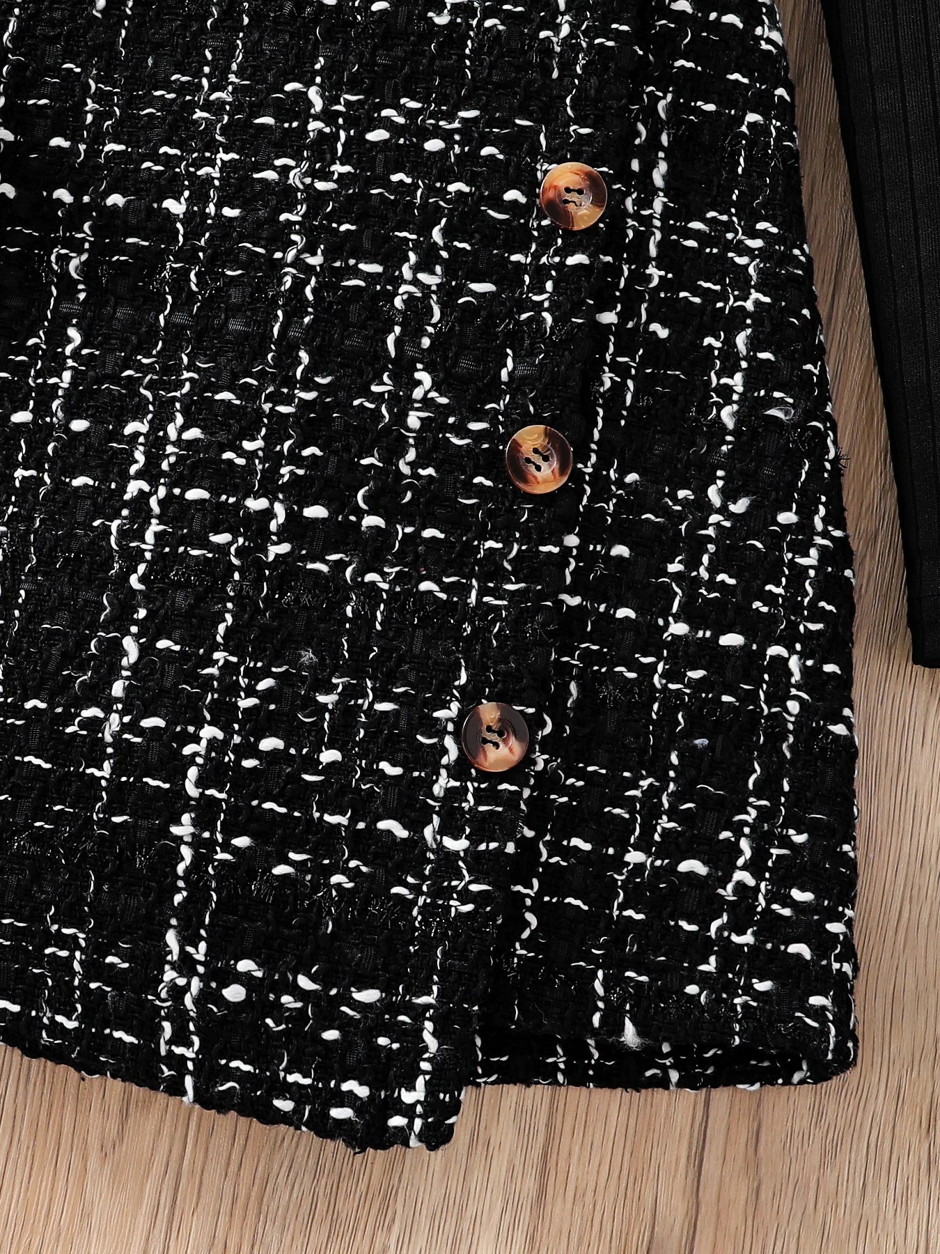 Kids Fashion Fall Set 2 Piece Black High Neck Petal Sleeve Top and A-line Skirt showing textured black and white buttoned skirt detail