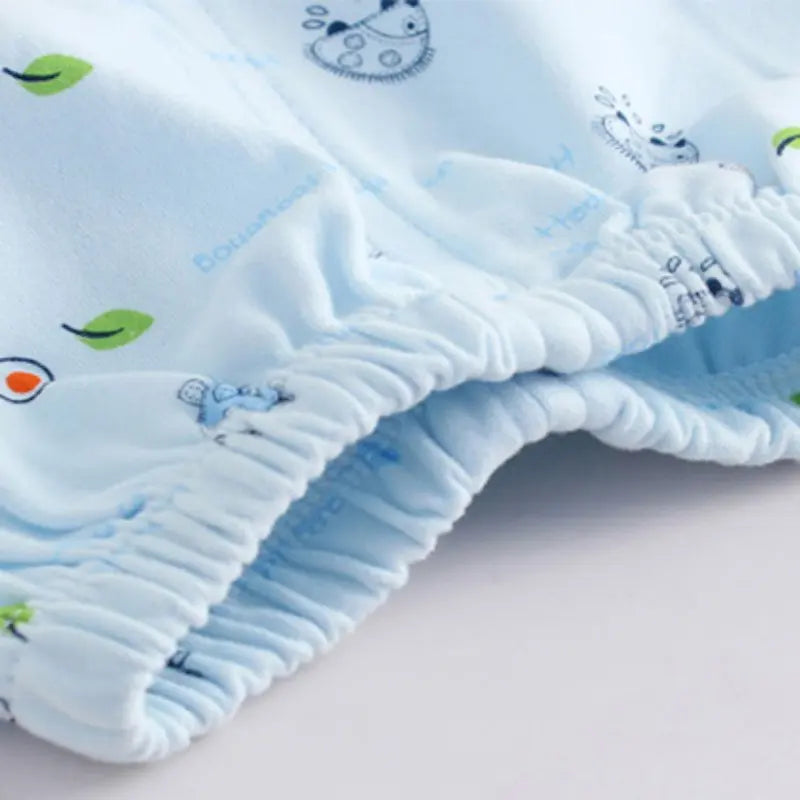 Newborn Baby Pure Cotton Clothing Set with Top Pants Hat Bibs Cartoon Print soft blue fabric close-up