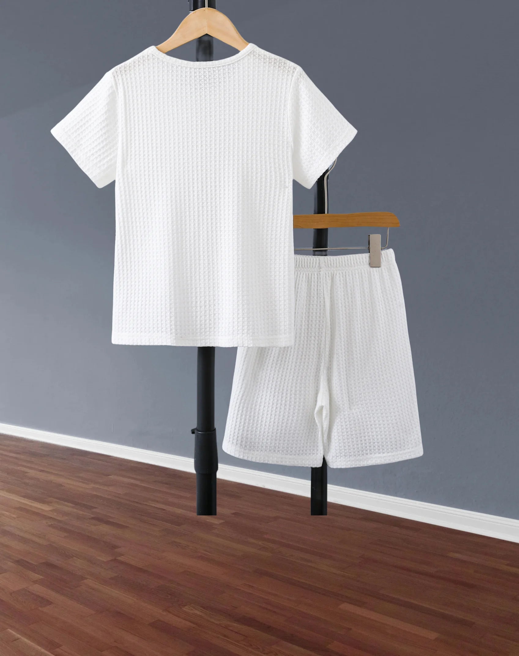 Stylish Boys Outfit Set Trendy Short Sleeve Shirt and Shorts Summer Design in white waffle fabric hanging on wooden hangers
