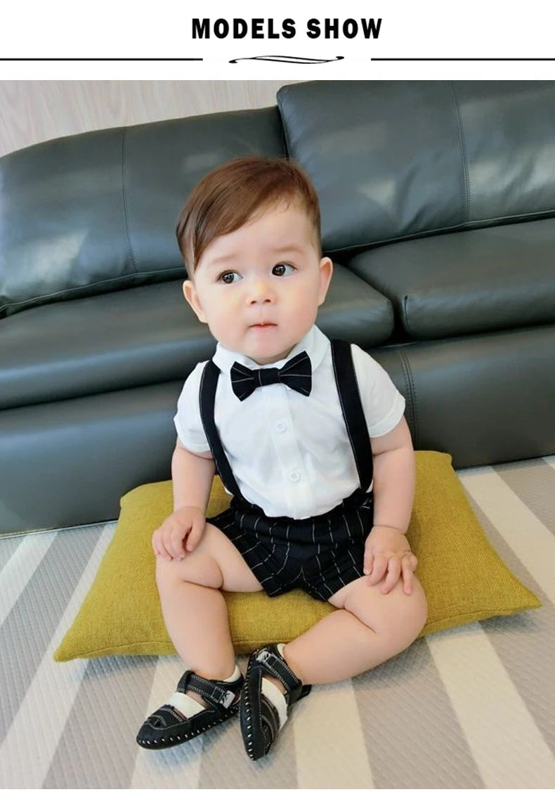 Toddler boy wearing Toddler Boy Birthday Outfit Summer Formal Shirt and Shorts Clothing Set with bow tie and suspenders indoors