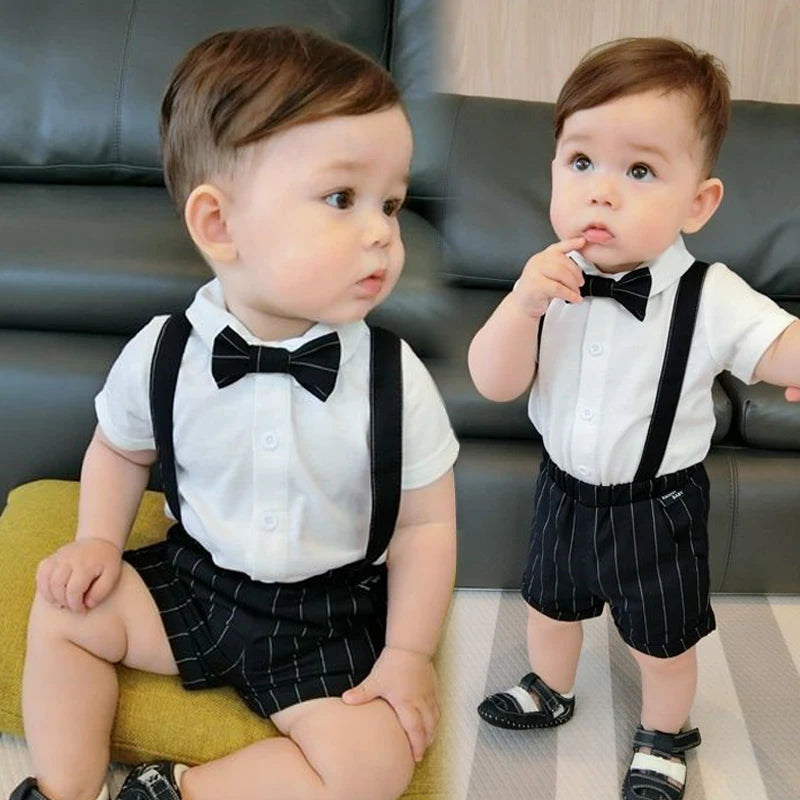 Toddler boy wearing a summer formal shirt and shorts clothing set with suspenders and bow tie for birthday