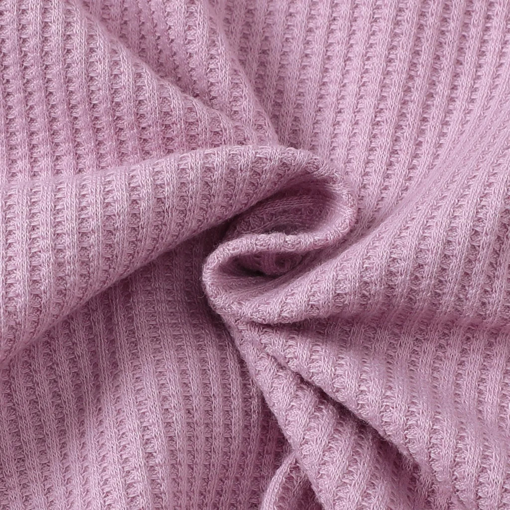 Close up of soft pink waffle knit fabric for Toddler Girl Clothes Set Long Sleeve Solid Top and Floral Pants Spring Autumn