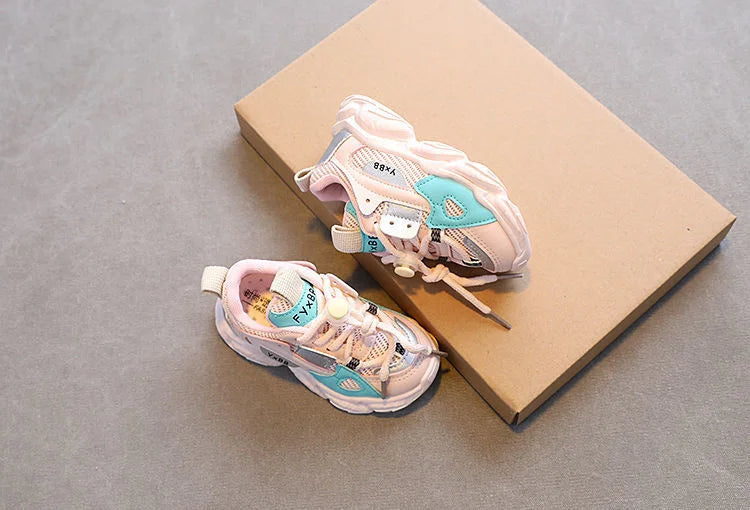 Breathable Mesh Kids Casual Sneakers Non-Slip Sport Shoes for Boys and Girls in pastel colors on a brown box